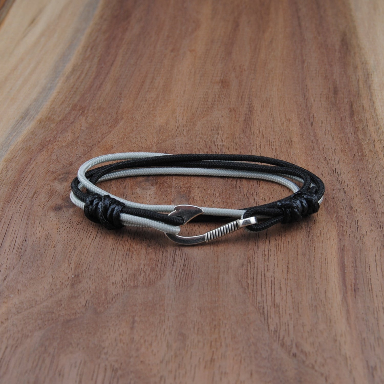 Black and silver bracelet on a wooden surface