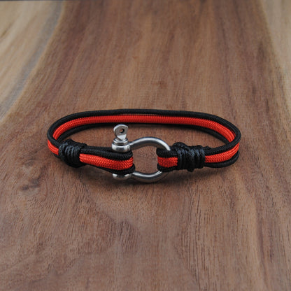 Black and red bracelet on a wooden surface