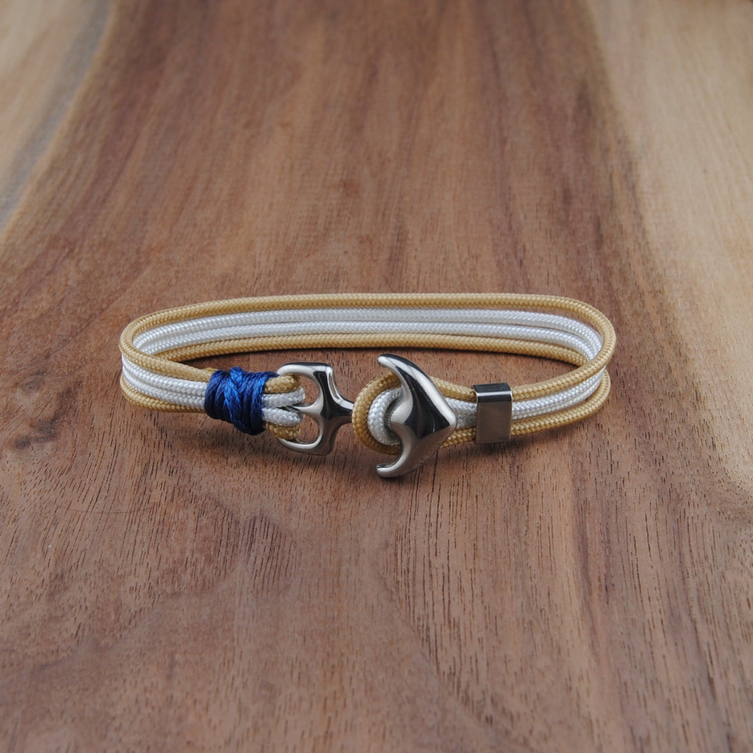 Bracelet with anchor charm on a wooden surface