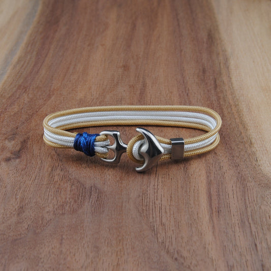 Bracelet with anchor charm on a wooden surface