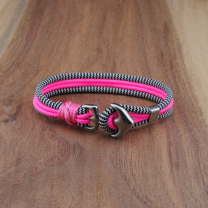 Pink and silver bracelet on a wooden surface