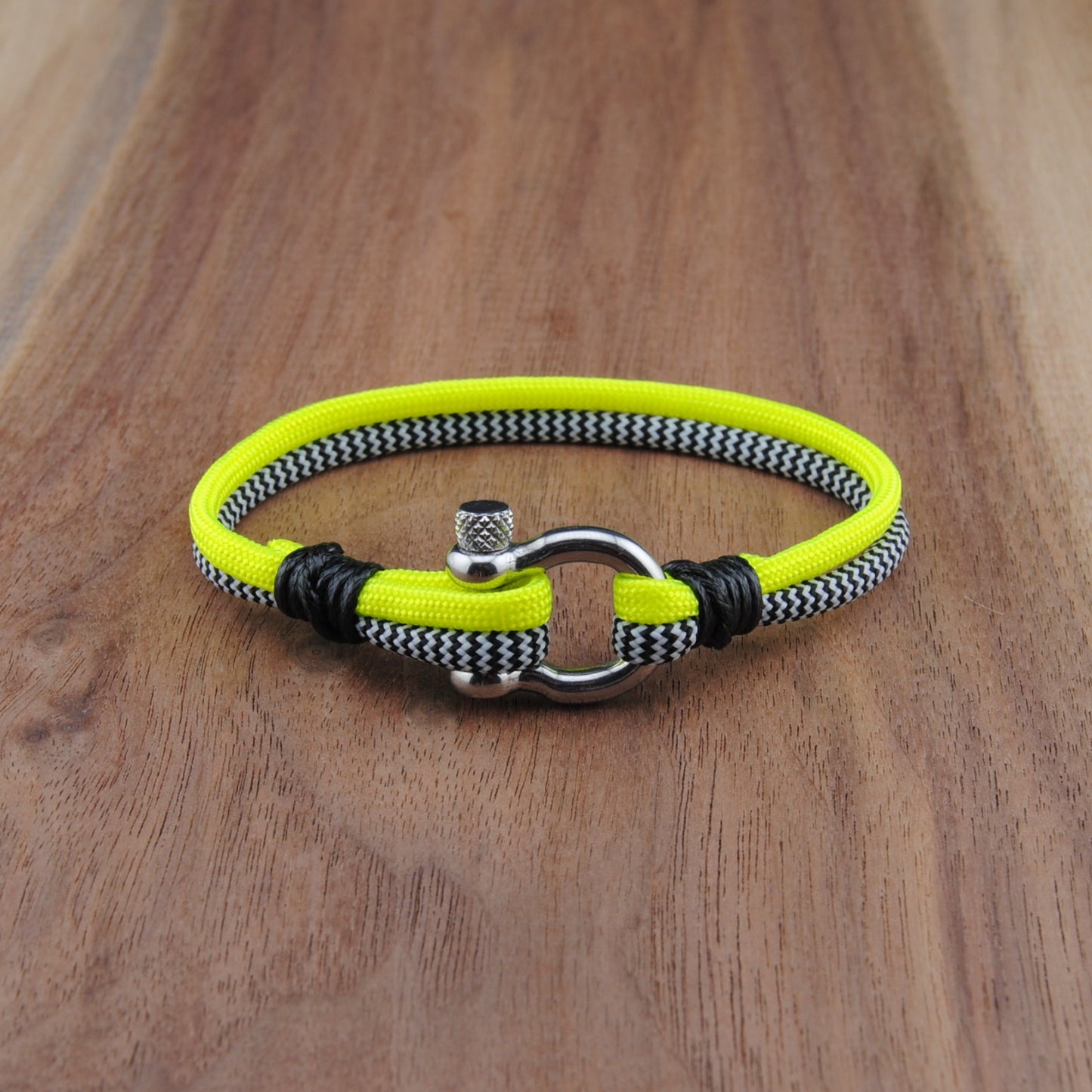 Neon yellow and black bracelet on a wooden surface