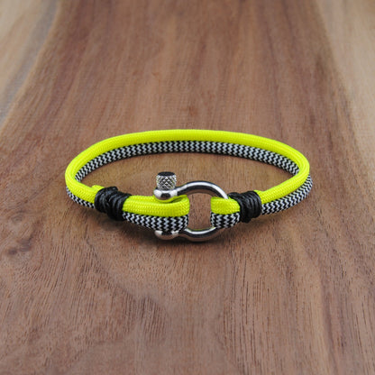 Neon yellow and black bracelet on a wooden surface